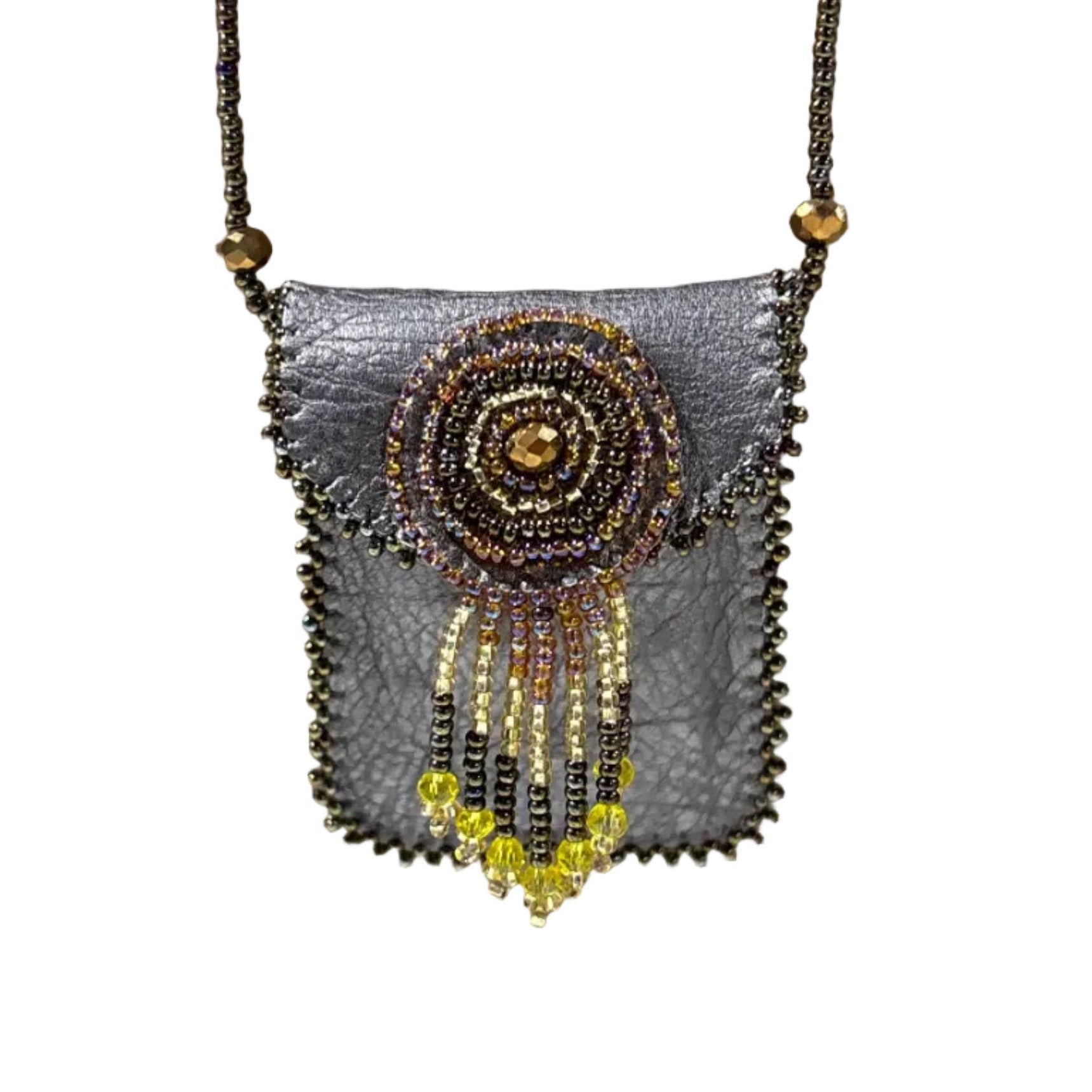 Decorative pouch with beaded design on a brown surface