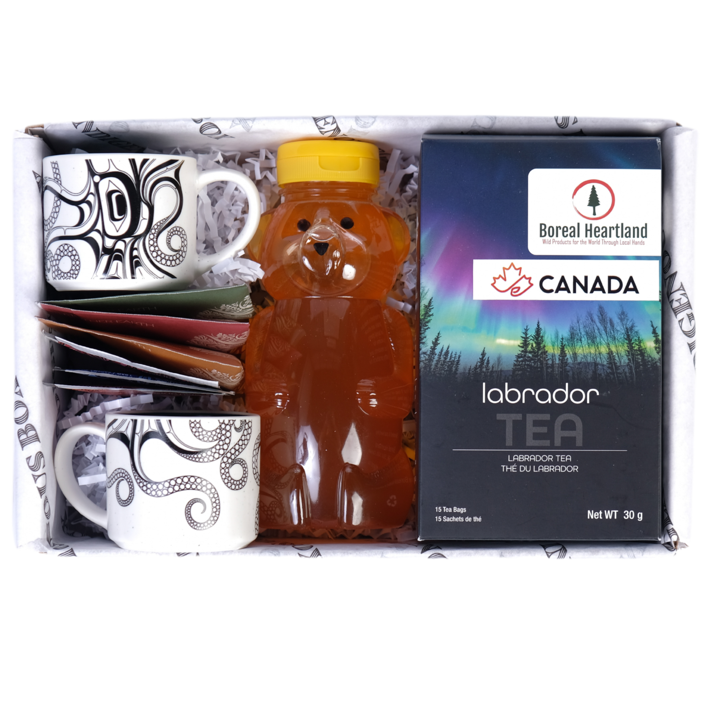 Gift set with bear-shaped honey container, mugs, and tea包 on a white background.