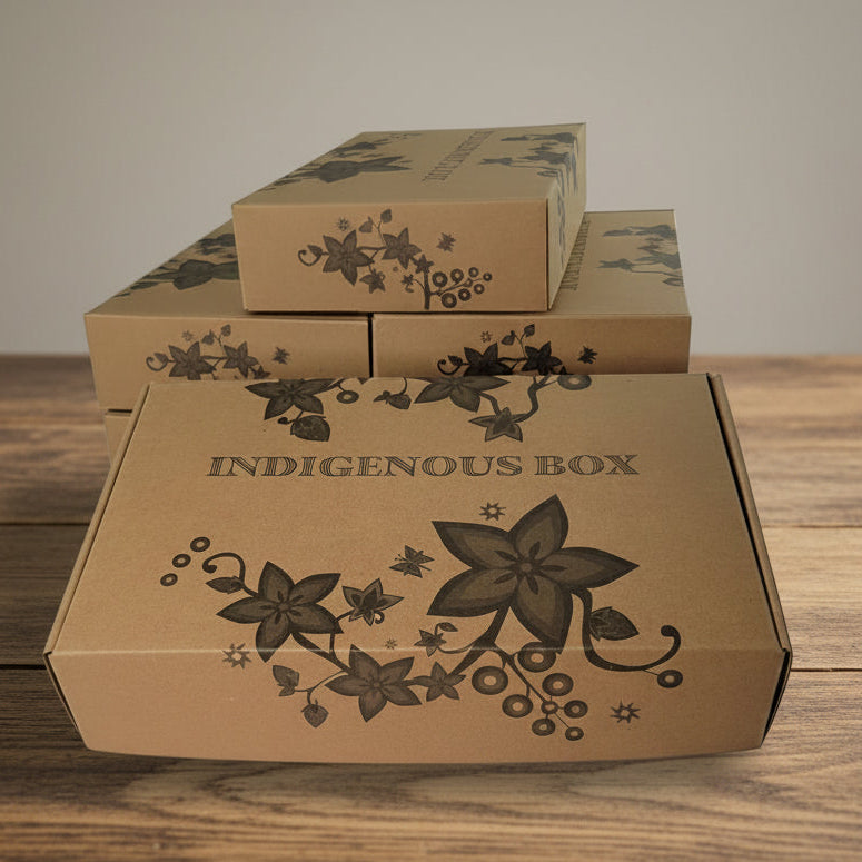 Set of brown cardboard boxes with floral designs and 'Indigenous Box' text on a light gray background