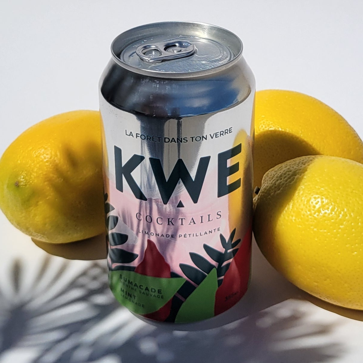 KWE cocktails can with lemons on a white background
