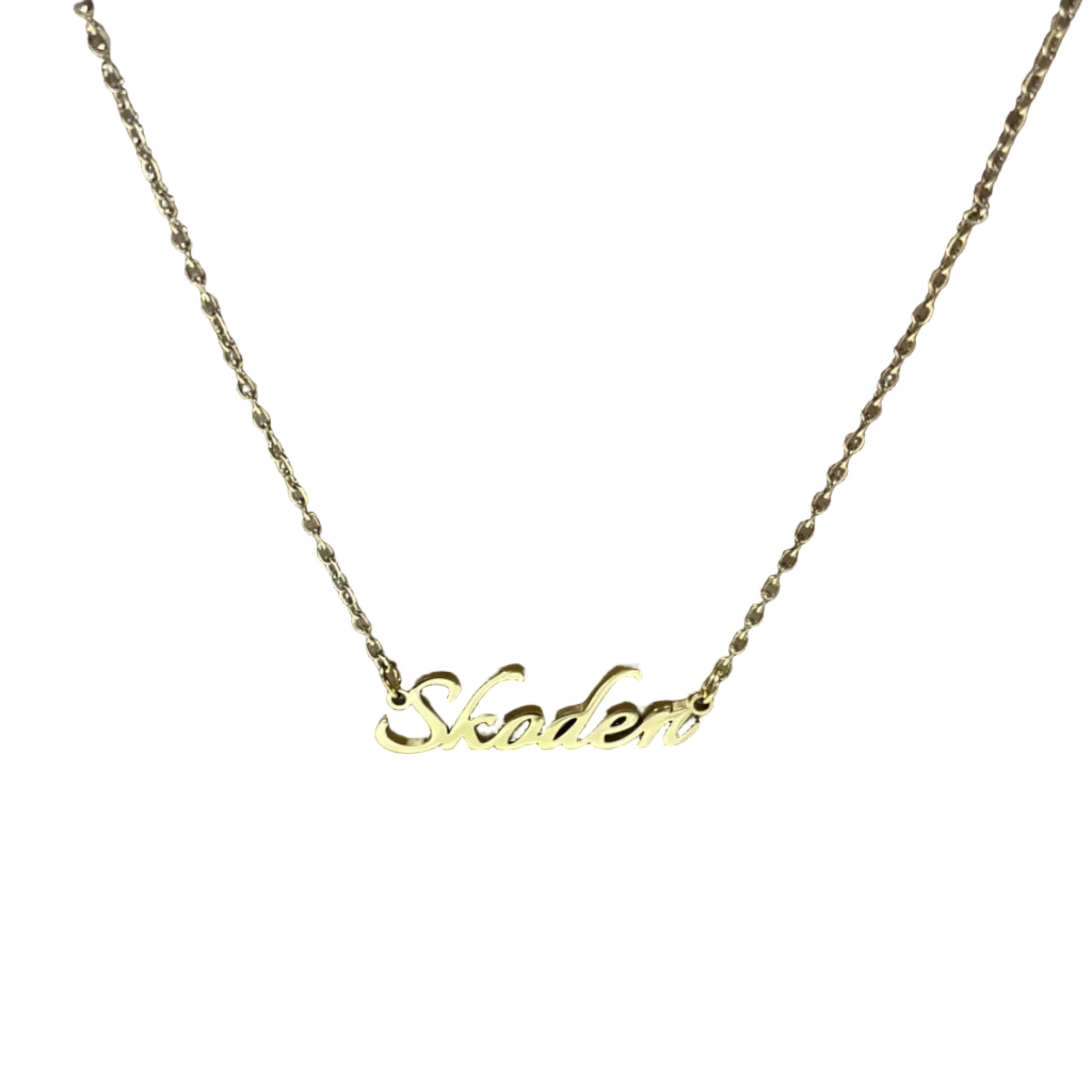 Gold necklace with 'Skoden' pendant on a brown surface